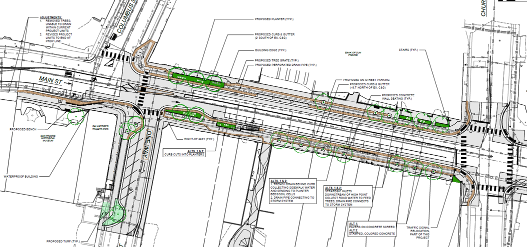 Engineering plan of Main Street showing proposed roadway changes, sidewalk improvements, landscaping areas, parking, and traffic lane adjustments with labeled measurements and annotations.